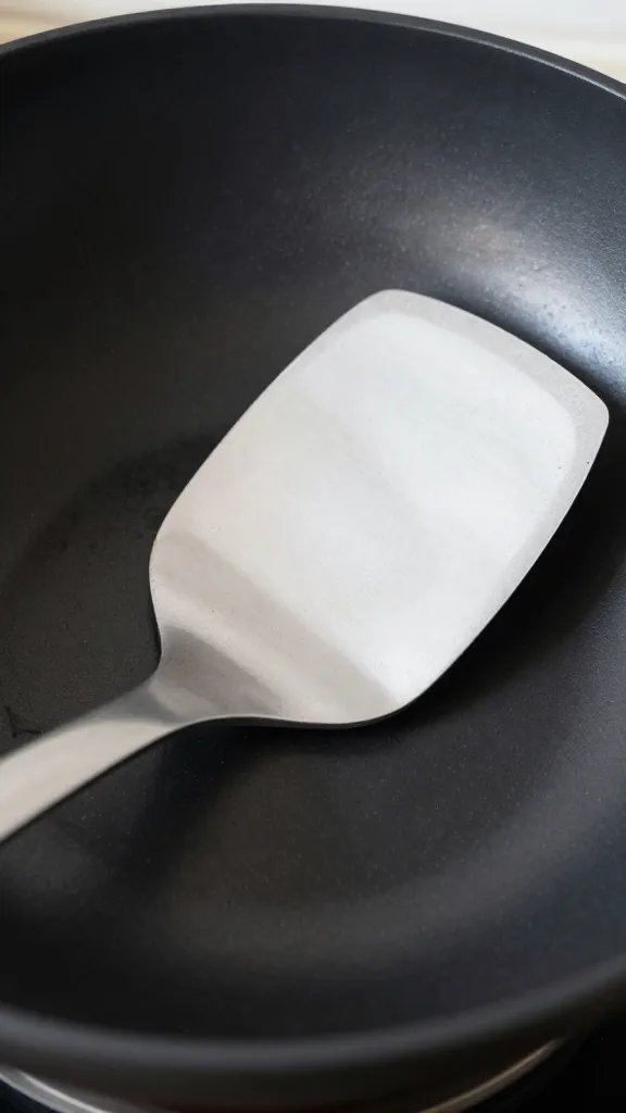 closeup of a single wok spatula resting in its dedicated tool slot
